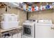 Organized laundry room featuring front-load washer and dryer and wire shelving at 9020 Breezy Meadow Way, Orlando, FL 32829