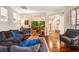 Cozy living room featuring hardwood floors, comfortable seating, and a staircase in the background at 9020 Breezy Meadow Way, Orlando, FL 32829