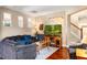 Comfortable living room featuring hardwood floors, comfortable seating, and a staircase in the background at 9020 Breezy Meadow Way, Orlando, FL 32829