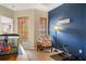 Inviting home office space featuring a charming accent chair, ample natural light, and an aquarium at 9020 Breezy Meadow Way, Orlando, FL 32829