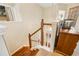 Upstairs hallway with wooden stairs and white railing, close to laundry room at 9020 Breezy Meadow Way, Orlando, FL 32829