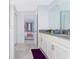 Bright bathroom with double sinks, granite counters, and an ensuite bedroom at 9332 Sommerset Hills Dr, Davenport, FL 33896