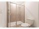 The renovated bathroom showcases a sleek glass-enclosed shower and modern fixtures, enhancing its spa-like feel at 9332 Sommerset Hills Dr, Davenport, FL 33896
