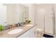 Bright bathroom featuring double sink vanity, quartz countertop and glass enclosed shower at 9332 Sommerset Hills Dr, Davenport, FL 33896