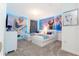 bedroom with two twin beds, 'Frozen' wall art, and neutral carpet at 9332 Sommerset Hills Dr, Davenport, FL 33896