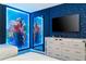 Fun bedroom features a mirrored dresser, and whimsical, lighted Mickey Mouse wall art at 9332 Sommerset Hills Dr, Davenport, FL 33896