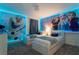 bedroom with two twin beds, 'Frozen' wall art, and neutral carpet at 9332 Sommerset Hills Dr, Davenport, FL 33896
