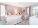 Lovely bedroom featuring two queen beds, pink accents, and geometric wallpaper at 9332 Sommerset Hills Dr, Davenport, FL 33896