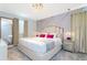 Relaxing bedroom featuring a stylish bed with decorative pillows, a modern chandelier, and ample natural light at 9332 Sommerset Hills Dr, Davenport, FL 33896