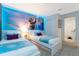 bedroom with two twin beds, 'Frozen' wall art, and neutral carpet at 9332 Sommerset Hills Dr, Davenport, FL 33896