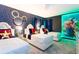 The vibrant bedroom is designed with unique wall art, plush beds, and modern lighting for an imaginative ' space at 9332 Sommerset Hills Dr, Davenport, FL 33896