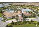Aerial view of a clubhouse featuring palm trees, and manicured landscaping in a Primary-planned community at 9332 Sommerset Hills Dr, Davenport, FL 33896