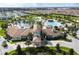 Aerial view of a clubhouse featuring pools, palm trees, and manicured landscaping in a Primary-planned community at 9332 Sommerset Hills Dr, Davenport, FL 33896