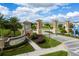 View of the ChampionsGate community entrance sign, landscaping, and well-maintained roadways at 9332 Sommerset Hills Dr, Davenport, FL 33896