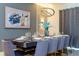 Elegant dining room with a large table, seating, stylish decor, and chandelier at 9332 Sommerset Hills Dr, Davenport, FL 33896