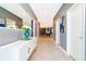 Hallway featuring stylish console table with decor, tiled floors and neutral wall color at 9332 Sommerset Hills Dr, Davenport, FL 33896