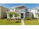 Inviting modern two-story home featuring a textured stone facade and well-manicured lawn at 9332 Sommerset Hills Dr, Davenport, FL 33896