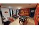 Open game room with pool table, foosball, plush seating, and Incredibles themed decor at 9332 Sommerset Hills Dr, Davenport, FL 33896