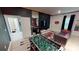 Entertaining game room features foosball, stylish seating, TV, and adjacent bathroom at 9332 Sommerset Hills Dr, Davenport, FL 33896