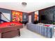 Spacious game room features a pool table, foosball, television, and Incredibles decor at 9332 Sommerset Hills Dr, Davenport, FL 33896