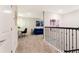 Bright hallway featuring a gray carpet, adjacent desk, and a blue couch that creates a stylish and functional space at 9332 Sommerset Hills Dr, Davenport, FL 33896