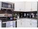 Modern kitchen featuring stainless steel appliances, gray countertops, and a stylish backsplash at 9332 Sommerset Hills Dr, Davenport, FL 33896