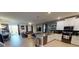 Open-concept living area with modern kitchen, dining table, and comfortable seating at 9332 Sommerset Hills Dr, Davenport, FL 33896