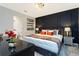 Elegant main bedroom with dark accent wall, mirrored nightstands, and ensuite access at 9332 Sommerset Hills Dr, Davenport, FL 33896