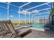 Gorgeous pool and spa under a screened enclosure with lounge chairs, perfect for outdoor relaxation at 9332 Sommerset Hills Dr, Davenport, FL 33896