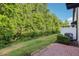 View of the backyard featuring a brick patio and lush landscaping providing privacy at 10404 Park Commons Dr, Orlando, FL 32832