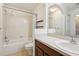 Bright bathroom with a shower-tub combo, tiled walls, and single sink at 10404 Park Commons Dr, Orlando, FL 32832
