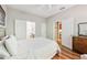 Bright bedroom featuring a bed, wood floors, and doors leading to the bathroom and kitchen at 10404 Park Commons Dr, Orlando, FL 32832