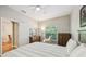Bedroom featuring neutral colors, a large window, and an open doorway to another room at 10404 Park Commons Dr, Orlando, FL 32832