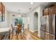 Dining area adjacent to kitchen with access to back yard and stainless steel refrigerator at 10404 Park Commons Dr, Orlando, FL 32832
