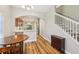 Dining room with hardwood floors, table, and adjacent open kitchen area at 10404 Park Commons Dr, Orlando, FL 32832