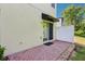 Cozy outdoor patio with brick pavers, privacy fence, and access to the home through a sliding glass door at 10404 Park Commons Dr, Orlando, FL 32832