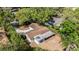 Aerial view of the property with mature trees, and a long driveway at 1051 Arden St, Longwood, FL 32750