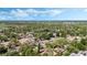 Overhead shot of a leafy residential area highlighting homes with swimming pools and mature trees at 1051 Arden St, Longwood, FL 32750