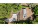 A top-down aerial shows the house and cracked driveway surrounded by trees at 1051 Arden St, Longwood, FL 32750