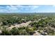 Expansive aerial view of the neighborhood showcasing the tree-lined streets and distant city skyline at 1051 Arden St, Longwood, FL 32750