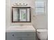 Bathroom features a gray vanity, mirror, and a window at 1051 Arden St, Longwood, FL 32750