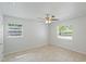 This light-filled bedroom features neutral paint, tile flooring, and two windows at 1051 Arden St, Longwood, FL 32750