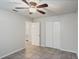 This bedroom features neutral paint, tile flooring, a closet, and an open doorway at 1051 Arden St, Longwood, FL 32750