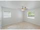 This light-filled bedroom features neutral paint, tile flooring, and two windows at 1051 Arden St, Longwood, FL 32750