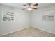 This light-filled bedroom features neutral paint, tile flooring, and two windows at 1051 Arden St, Longwood, FL 32750