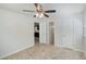 This bedroom features neutral paint, tile flooring, and two open doorways at 1051 Arden St, Longwood, FL 32750