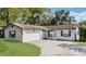 Charming single-story home featuring a two-car garage and well-maintained front lawn at 1051 Arden St, Longwood, FL 32750