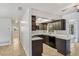 Modern kitchen with dark cabinetry, stainless steel appliances, and quartz countertops at 1051 Arden St, Longwood, FL 32750
