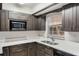 Close up of kitchen featuring quartz counters, dark cabinets, and stainless steel appliances at 1051 Arden St, Longwood, FL 32750