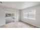 Bright living room features neutral paint, tile flooring, a window, and a sliding glass door at 1051 Arden St, Longwood, FL 32750